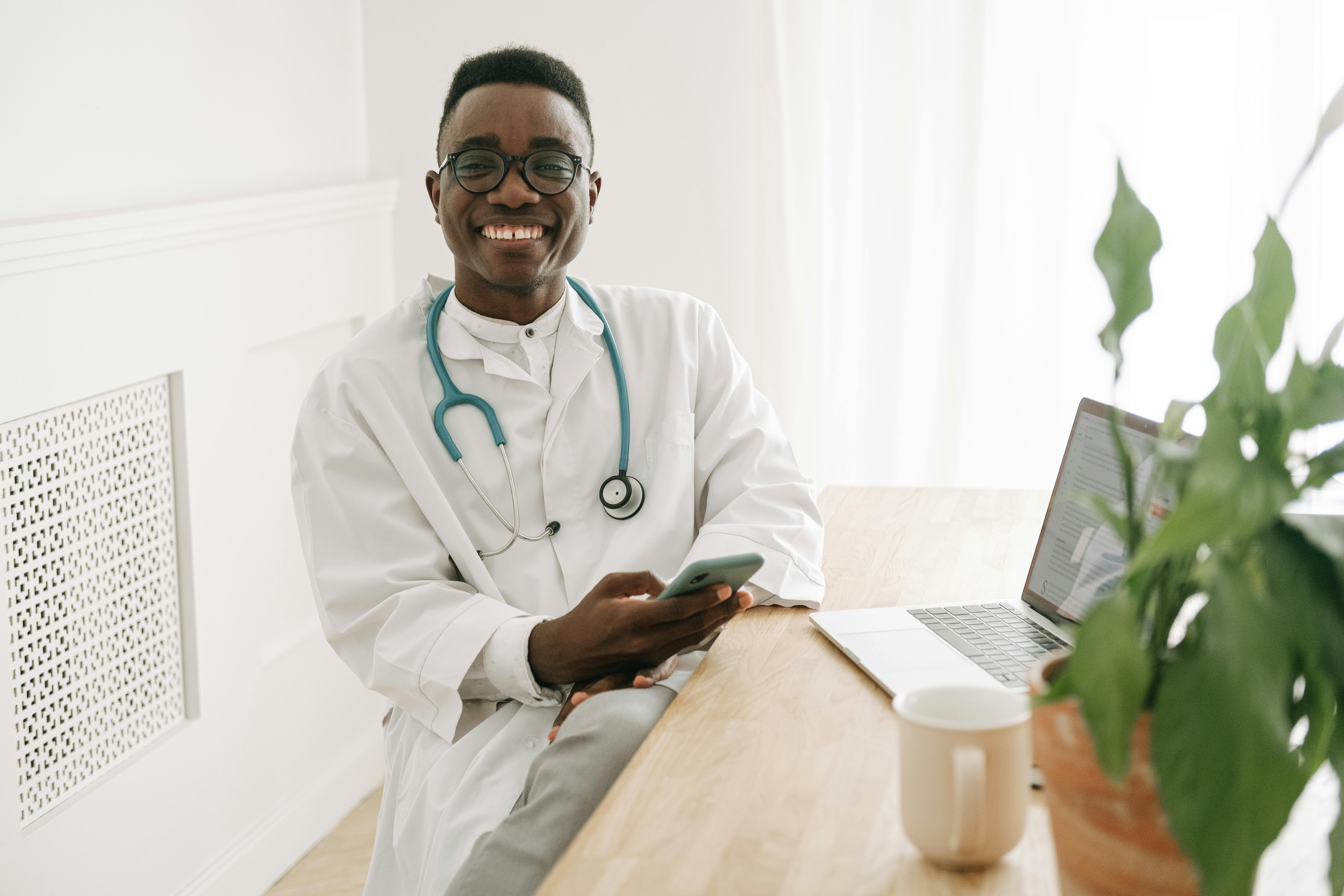 smiling physician sitting at a desk